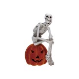 Resin Skeleton Sitting on Flocked Jack-O-Lantern